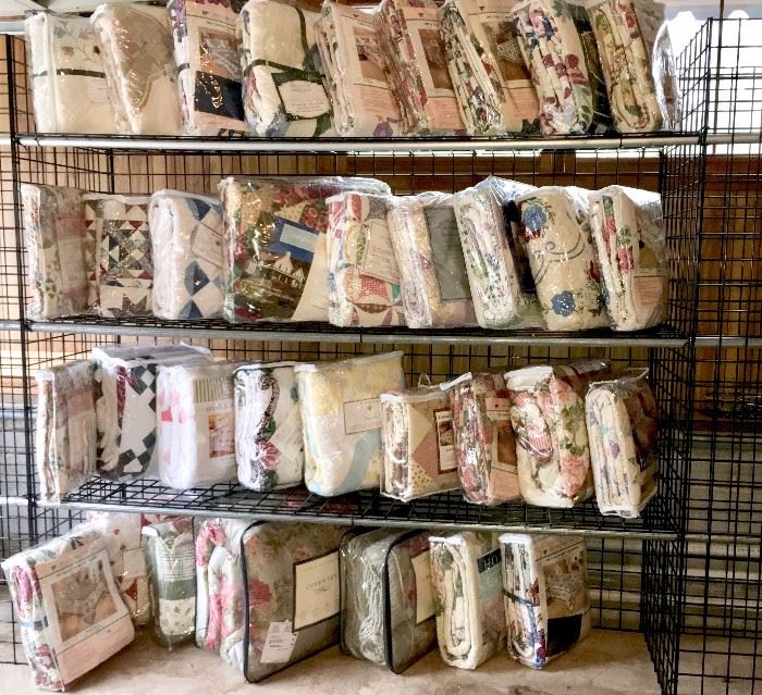A few of the m any available new-in-package quilts and comforter sets, many in king size