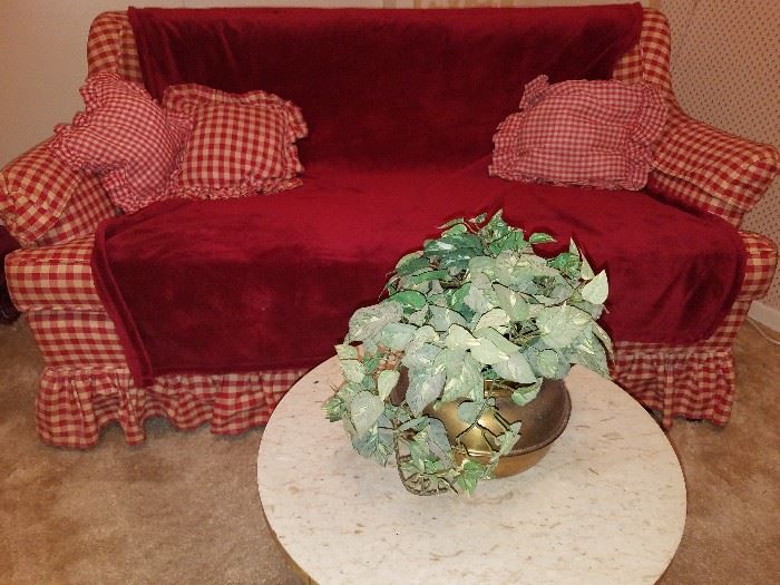 Love seat in red gingham and round side table. 
