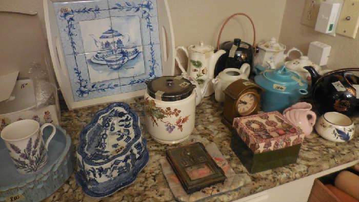 great collection of tea/coffee pots, cheese cover