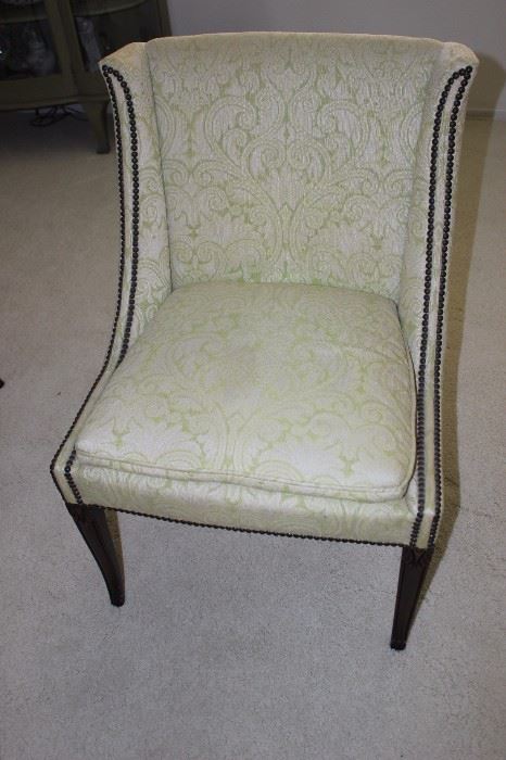 One of four upholstered chairs with hobnail trim.