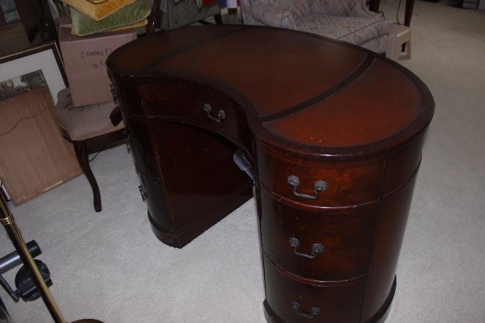 Kidney shaped leather inlaid writing desk.