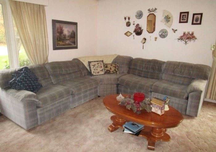 Large blue pattern sectional, coffee table, wall decor
