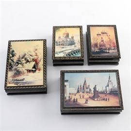 Russian Black Lacquered Trinket Boxes: An assortment of Russian black lacquered trinket boxes. This assortment of four wood pieces features scenes of Russia to the tops. They are all painted red to the interiors.