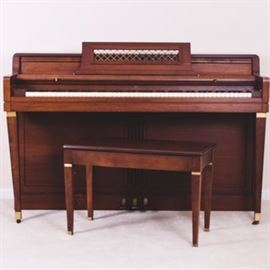 Vintage Wurlitzer Spinet Piano and Bench: A vintage 1966 Wurlitzer spinet piano, model 2020/OIL WAL and serial number 935338, with a beautiful oiled walnut frame, square tapered legs with bands of brass, and Wurlitzer logo to the center above keyboard. Original owner’s manual is included. A matching piano bench with hinged top and storage compartment is included.