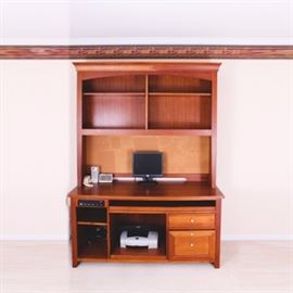 Contemporary Wooden Home Office Unit: A wooden home office unit complete with a master control panel, multiple drawers and hutch spaces, multiple shelves, a bulletin backboard and a generous desk surface. Appliances pictured are not included.