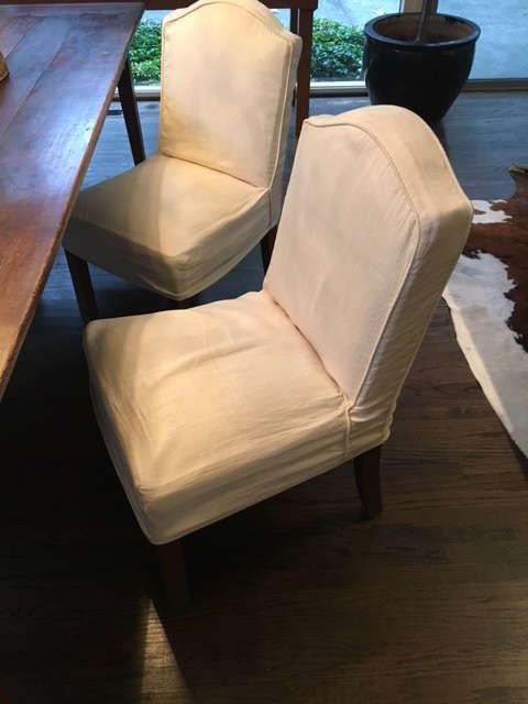 Two of four slip-covered side chairs.  There are also two matching arm chairs