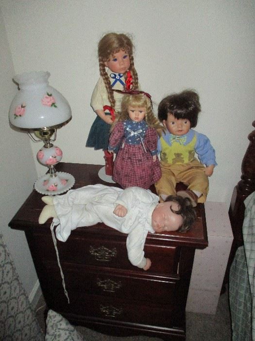 Drake dolls, sitting on top of a cherry night stand.  One of two.