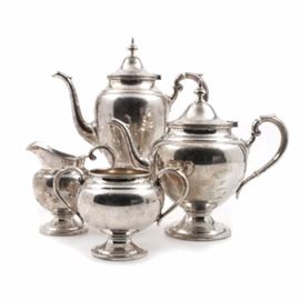 1966 Gorham Sterling Silver Coffee and Tea Service: A vintage sterling silver coffee and tea service by Gorham in the pattern numbered 451. The set is simple and classic in styling comprising a footed coffee pot, teapot, creamer and two handled sugar; both the coffee pot and teapot are marked to be 2.5 pints with reinforced handles and faux ivory insulators. All pieces are stamped with the Gorham pseudo hallmarks, “Gorham Sterling”, “Reinforced Handle”, and a date code of a number six in a hexagonal cartouche for 1966. The total appropriate weight, including the reinforced handles, is 55.225 ozt.