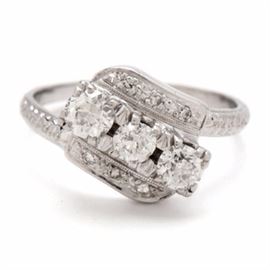 14K White Gold Vintage Ring Featuring Three Old European Cut Diamonds: A 14K white gold vintage ring featuring three old European cut diamonds prong set diagonally in a raised setting with six accent diamonds.