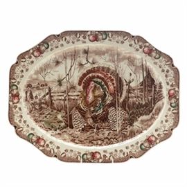 Vintage Johnson Bros. "His Majesty" Turkey Platter, Made in England: A vintage Johnson Bros. His Majesty turkey platter, made in England. The extra large platter feature a genuine hand engraving in sepia to depict the turkey in his full glory at the center of a farm landscape. The rectangular platter has a scalloped rim illustrated with fruit and fall flowers.