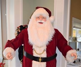 Vintage Santa Claus 7 ft tall with sack of toys on his back!!! He's terrific and really brings Christmas to "life".  Guaranteed to be the talk of your Christmas gathering with his crisp suit and cheerful smile!  The pointer finger on his left hand was broken off and glued back on.  Other than that, he appears to be in very good condition.