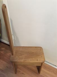 Small hand crafted stool with back that has handle.  Sturdy...can be used to stand on.