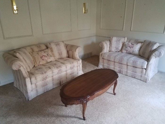 Pair of matching love seats and queen anne coffee table.