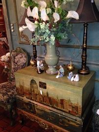 Painted chest; mud men; decorative lamps; calla lily arrangement
