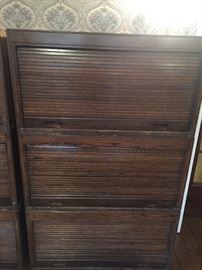 1 of a pair of antique oak roll lift storage cabinets which are unfinished on the sides