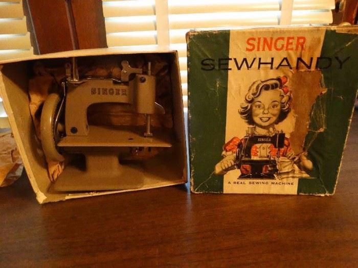Mini vintage singer sewing machine.