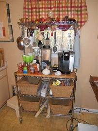 Baker's rack with baskets, Keurig coffee maker, and Waring Smootherator blender