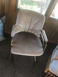 Upholstered chair with metal arms