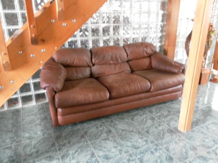 Leather couch - has matching chair and ottoman