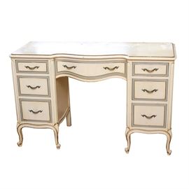 Vintage Drexel French Provincial Desk: A vintage Drexel French Provincial desk. The wood desk has a white painted finish, with blue-gray accents. There are three dovetailed drawers to either side of the knee hole opening, with another drawer at the center. The desk drawer fronts are embellished with blue gray borders around the panels, and they have brass tone metal pulls. The desk rests on short, cabriole legs, and is marked “43075 – The Touraine Collection 349 by Drexel”.