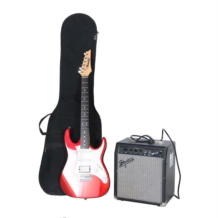 Ibanez Gio Electric Guitar, Case and Squier Amplifier: A solid-body Ibanez Geo electric guitar, model GRX40 and serial number CZ802948, with a candy apple red finish and a white pickguard; it features one humbucker and two single-coil pickups with a five-way pickup selector, volume control, and tone control. Included is a Squier amplifier, model BP-15 and serial number BP1519418, and a black Fender gigbag style case.