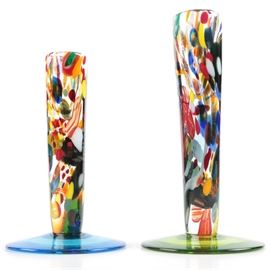 Art Glass Vases Featuring Colorful Interiors: A pair of art glass vases featuring colorful interiors of stretched canes and colors. The shorter vase features a blue glass foot signed to the bottom “AMW” the rest is not readable. The next vase has a yellow foot, and a signed to the base “ROG AMW 010” with the rest being not readable.