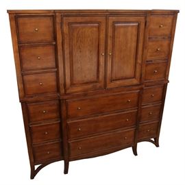 American Signature Traditional Style Dresser: A American Signature Traditional style dresser in a walnut finish with drawers, labeled, “American Signature Furniture”. The slightly projected center, features two raised-panel doors, over an open cabinet, above three drawers, flanked by six drawers on each side. Some have cedar bottoms, to repel moths.The case rests on splayed feet.