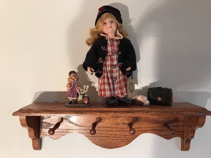 Coat rack shelf with antique dolls