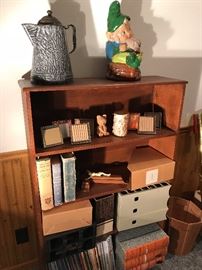Oak book case filled with books, coffee pot, pottery