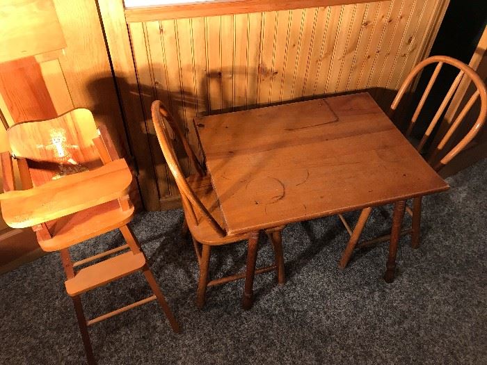 Small, child-like table and oak chairs together with a high chair