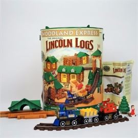 Lincoln Logs "Woodland Express" Train Set: A Lincoln Logs Woodland Express train set. Stored in the original container, this set features real wooden logs, roofs, windows, doors, frames, train cars with track, and accessories. The original instruction booklet is included.