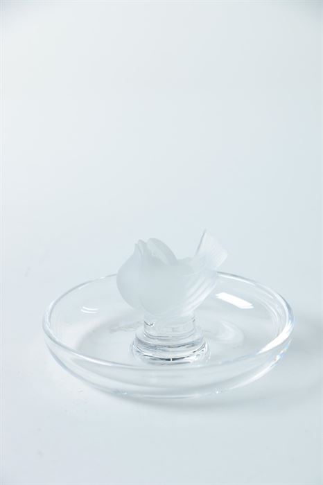 Lalique "Sparrow" Ring Holder: A Lalique Sparrow r ring holder. This ring holder features a delicately crafted sparrow finial to the top of the shallow, round crystal dish. The bottom of the dish is signed “Lalique France”