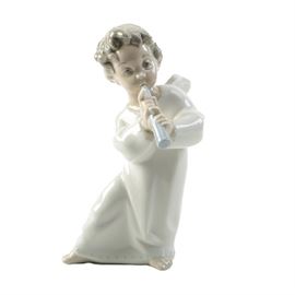 Lladro Angel with Flute Figurine: A Lladro Angel with Flute figurine. This porcelain figurine, No. 01014540, is associated with sculptor Fulgencio García. It features a young angel playing a flute. This figurine was first issued in 1970 and retired in 2005. The piece is stamped on the bottom, “LLADRO Hand Made in Spain”.