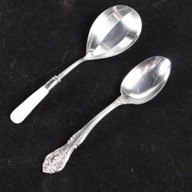 Gorham "King Edward" Sterling Tablespoon with Griffin Cutlery Works Spoon: A pairing of serving spoons. This includes a sterling silver tablespoon by Gorham in the J. Russell Price King Edward pattern, first introduced in 1936, which features a floral and acanthus leaf accented handle. It is marked to the back of the handle “Gorham Sterling Pat.” It is presented with a casserole spoon by Griffon Cutlery Works, which has a silver-plated bowl and stem, a marked sterling bolster, and a mother of pearl handle. The approximate weight of the Gorham spoon is 2.480 ozt.