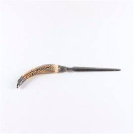 Faux Antler Letter Opener: A letter opener. This features a metal letter opener with an off-white faux antler handle flanked by ornate silver tone accents.