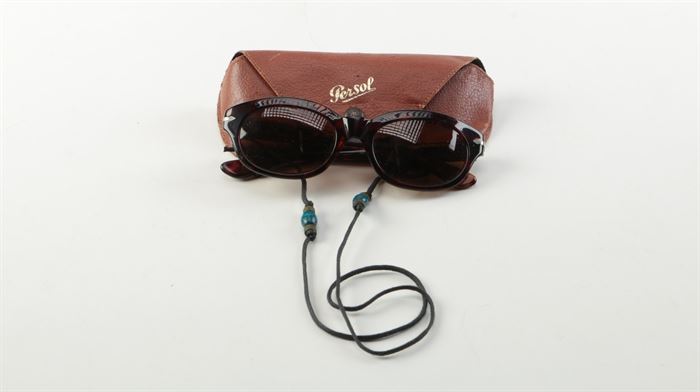 Women's Persol Cat Eye Sunglasses with Case: A pair of women’s Persol cat eye sunglasses with a case. These cat eye sunglasses feature tortoise style acrylic frames, brown tinted lenses and gold-tone accents to the temples. Also included, a Persol-branded brown carrying case and a black strap with green and blue bead accents.