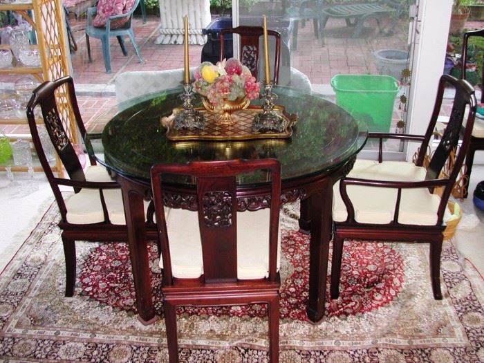 Asian motif table with custom glass top.  Comes with 6 chairs and leaf extenders.