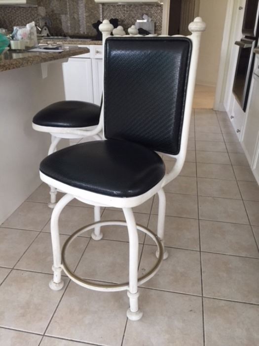 Two beautiful countertop bar stools, swivel seats, leather covering backs and seats. 