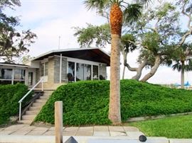 Frank Lloyd Wright designed home, surrounded on two sides by 200 ft of water frontage with deep water mooring & located on a 3/4 acre point of prime elevated  land .