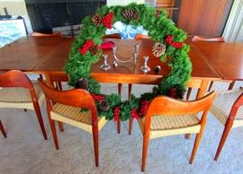 Mid Century Danish Teak Dinning Table with 8 Teak & Cane Seated Chairs. Table is 8.7 feet long and 3.7 ft wide.