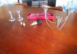 Sterling Mid Century Tri-pod candle holder, two sterling candle sticks, sterling salt & pepper, a sterling crumb brush and a sterling handled carving set.