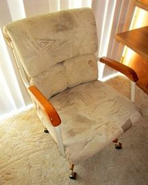 Office chair. Are the arm rests and legs teak?..we don't know but such things do exist. Staining  on the material--cleanable