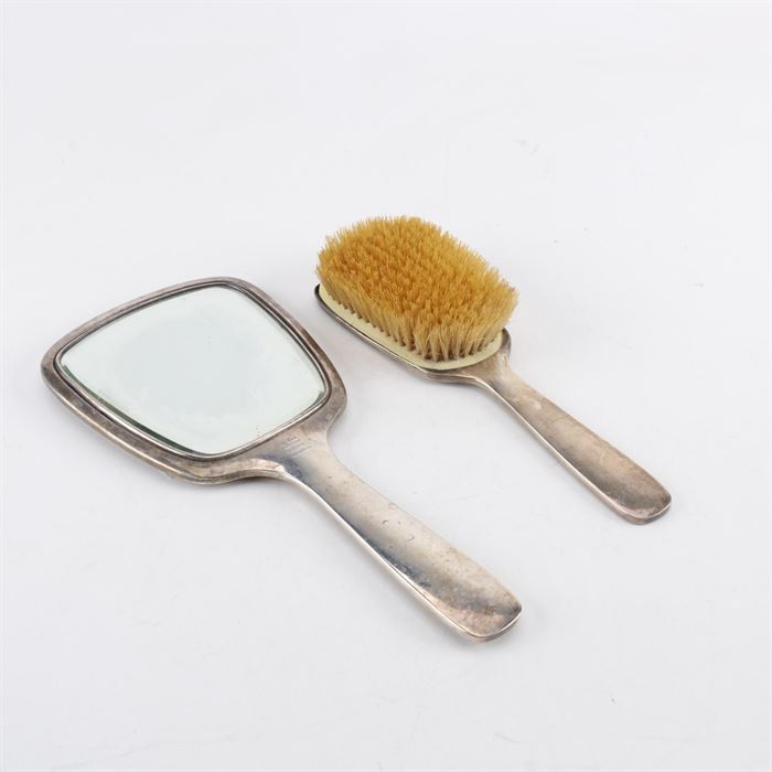 Hand Hammered Sterling Silver Vanity Set: A hand hammered sterling silver vanity set. This includes a hand mirror with a beveled mirror and a hair brush. The pieces have simple handles with personalized engravings on the back. Each is marked with the makers mark and “Hand Hammered.”