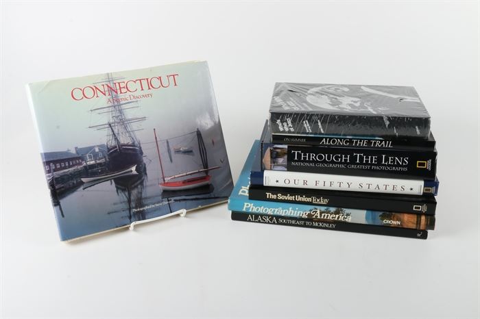 Collection of Photo Books: A collection of photo books. This collection includes a copy of Connecticut: A Scenic Discovery (Foremost Publishers; 1980) by Steve Dunwell, a copy of Along the Trail: A Photographic Essay of Glacier National Park and the Northern Rocky Mountains (Lowell Press; 1980) by Danny On and David Sumner, a copy of Through the Lens: National Geographic Greatest Photographs (National Geographic; 2009) by National Geographic and more. There is a total of eight books.