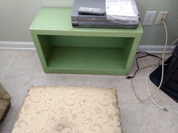 Cute green shelf.  Could be mounted on the wall!
