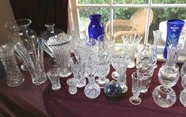 A collection of large vases, bud vases, and rose bowls