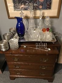 A small mahogany server set with bar ware including Versace bottle stoppers Waterford decanters and An American crystal decanter