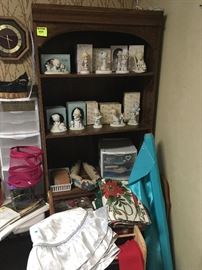 bookshelf and collectible Precious Moments figurines, Christmas table linens and tree skirts, quilt racks