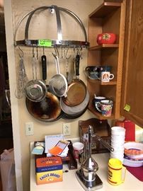 pans, pot rack, juicer on a stand