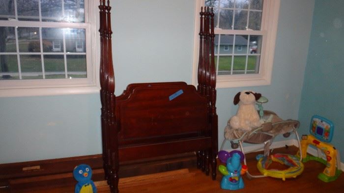 Two matching twin size four poster beds in excellent condition.   Side rails and center posts all present.   Lots of children's things in this same room.  